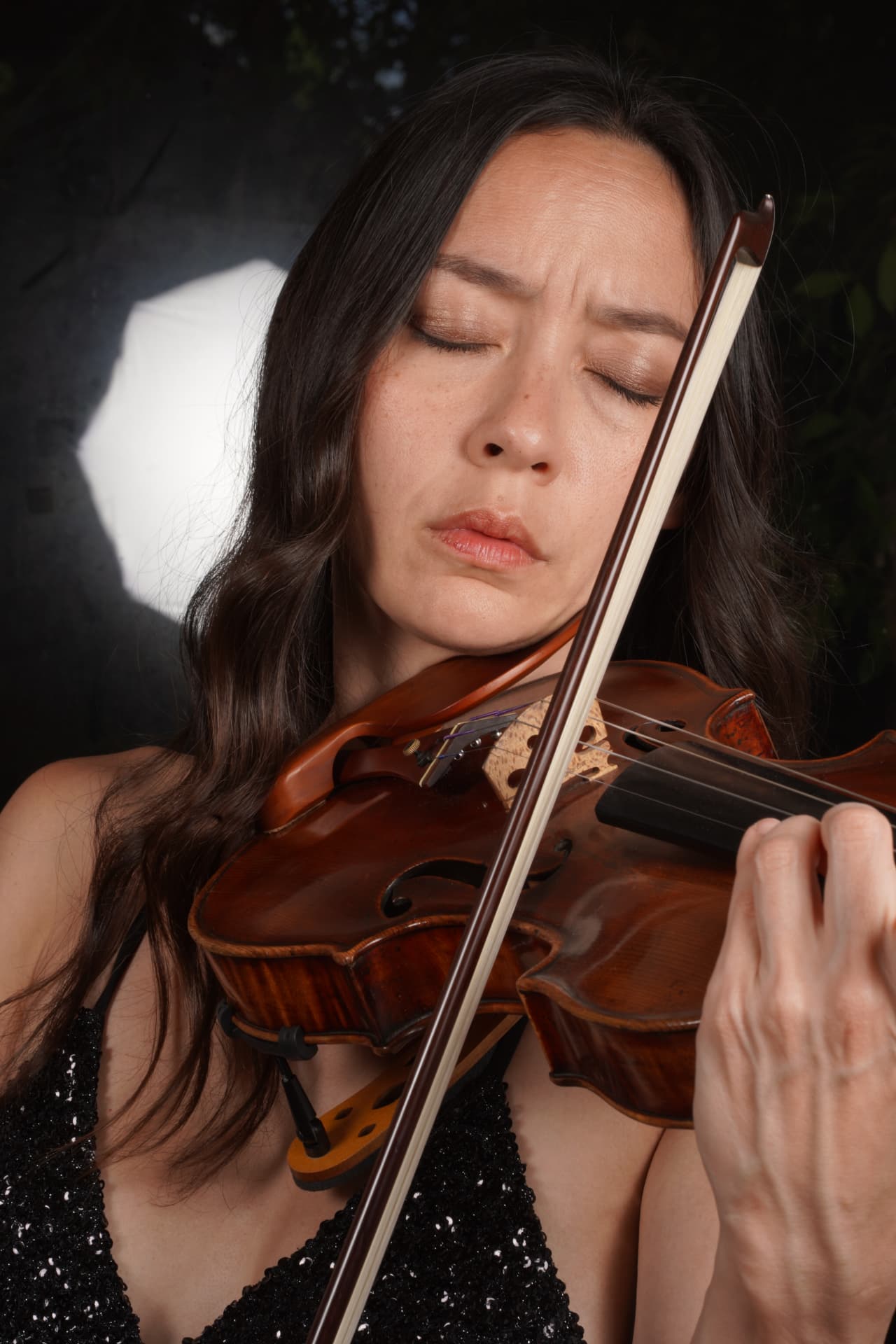 Lucia Micarelli playing violin, eyes closed
